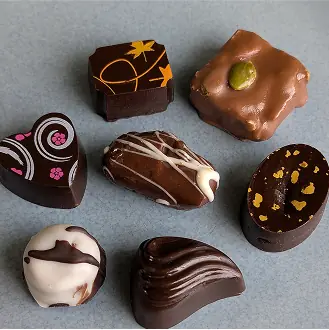 Two chocolate shaped hearts representing the finely crafted nature of the chocolates